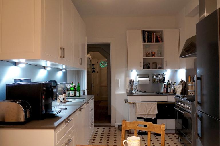 Landhausküche mit weißen Fronten und dunkler Arbeitsplatte